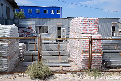 Warehouse of building materials. Building base, metal, wood and blocks with bricks Editorial Stock Photo