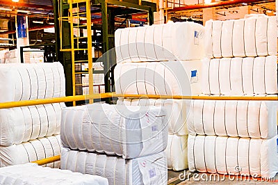 Warehouse with a bunch of huge, white, rectangular bags with acrylic fiber Stock Photo