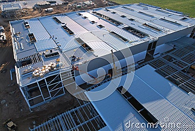 Warehouse Construction from metal structure. Industrial building on light gauge steel framing. Frame of modern hangar or factory. Stock Photo