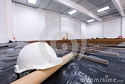 Warehouse construction site. White engineer helmet on floor Stock Photo