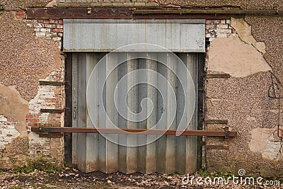 Abandoned old Warehouse with steel shutter doorway Stock Photo