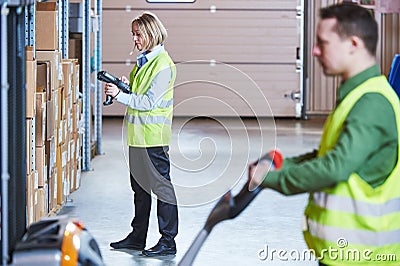 Warehouse Management System. Workers with barcode scanner and stacker Stock Photo