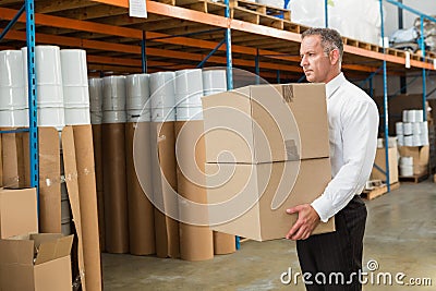 Warehouse manager carrying cardboard boxes Stock Photo