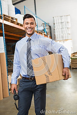 Warehouse manager holding cardboard box and scanner Stock Photo