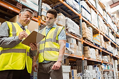 Warehouse manager speaking with foreman Stock Photo