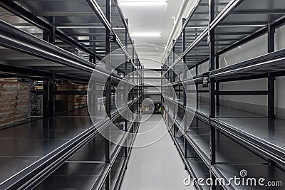 Warehouse racks storage metal pallet racking system in warehouse. Modern interior of new empty warehouse. The shelves are pallet Stock Photo