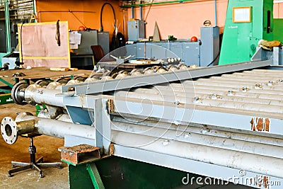 Warehouse, storage of metal iron long stainless pipes with flanges, passages and branches at the petrochemical, metallurgical Stock Photo