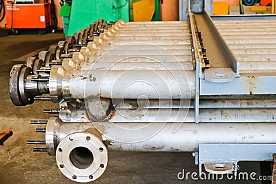 Warehouse, storage of metal iron long stainless pipes with flanges, passages and branches at the petrochemical, metallurgical Stock Photo