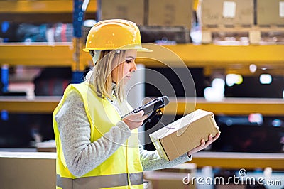 Warehouse woman worker with barcode scanner. Stock Photo