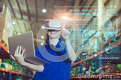 warehouse worker enjoy using advance modern technology VR overlay digital data infographics interface monitor tracking cargo Stock Photo