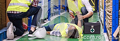Warehouse worker frist aid after accident panoramic Stock Photo
