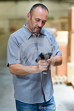 warehouse worker programming handheld scanner Stock Photo