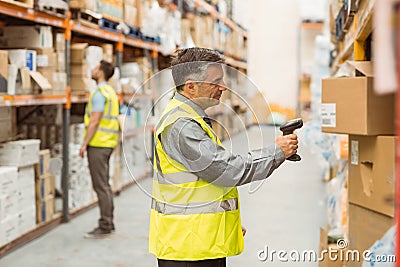 Warehouse worker scanning barcode on box Stock Photo