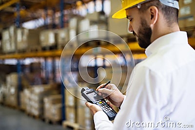 Warehouse worker or supervisor with barcode scanner. Stock Photo