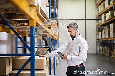 Warehouse worker or supervisor with barcode scanner. Stock Photo