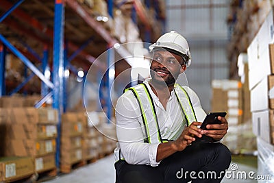 Warehouse worker working process checking the package with a tablet in a large distribution center Stock Photo