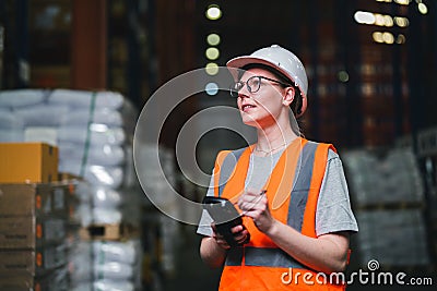 Warehouse worker working process checking the package using barcode reader in a large distribution center Stock Photo