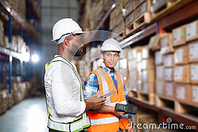 Warehouse worker working process checking the package using laptop in large warehouse distribution center Stock Photo