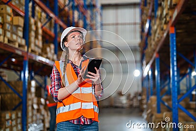 Warehouse worker working process checking the package using a tablet in a large warehouse distribution center Stock Photo