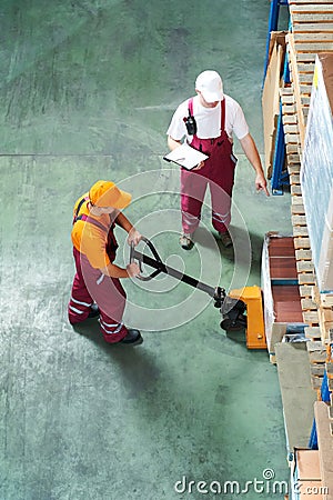 Warehouse workers with fork pallet Stock Photo