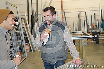 Warehouse workers having lunch break Stock Photo