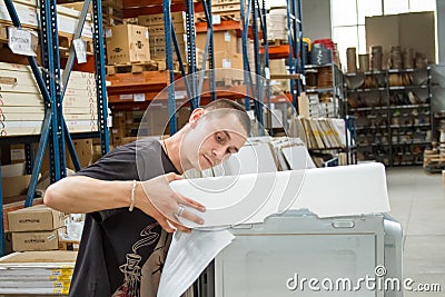 Warehouse workers pack equipment before shipment to customer Editorial Stock Photo