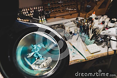 Magnifying glass lens view of a miniature for wargames Editorial Stock Photo