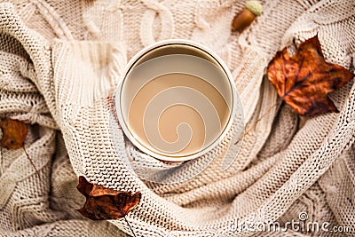 Warm autumn. cup of coffee wrapped in a woolen beige sweater. still life Stock Photo