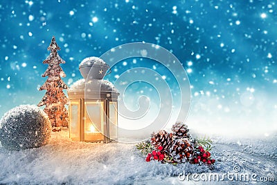 Warm candle light in a snowy winter landscape Stock Photo