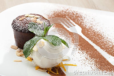 Warm chocolate cake Fondant with ice-cream ball, almond, mint, c Stock Photo