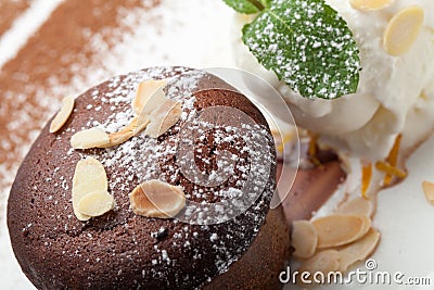 Warm chocolate cake Fondant with ice-cream ball, almond, mint, c Stock Photo