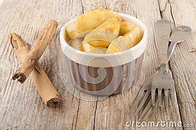 Warm cinnamon apple slices in a bowl Stock Photo