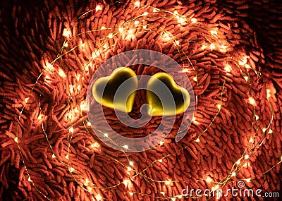 A warm color light garland surrounding two hearts. valentine`s day Stock Photo