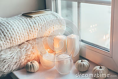 Hygge scene with sweater and candles Stock Photo