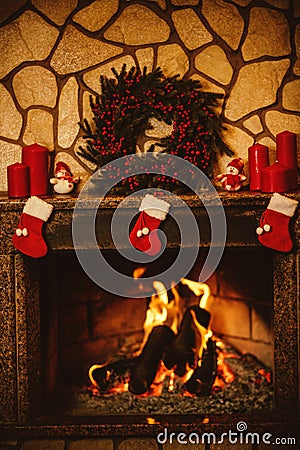 Warm cozy fireplace decorated for Christmas with real wood burni Stock Photo