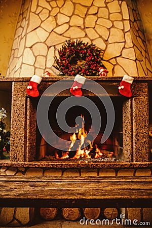 Warm cozy fireplace decorated for Christmas with real wood burni Stock Photo