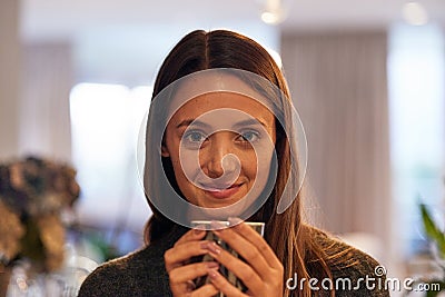 A warm cup of tea picks me right up. Portrait of a young woman drinking a warm beverage at home. Stock Photo