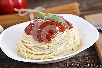 Warm, delicious spaghetti with sauce and basil Stock Photo