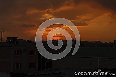 warm dusk with cloudy sky and cityscape silhouettes Stock Photo