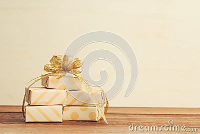 Warm filtered gifts wrapped in natural craft paper on wood Stock Photo