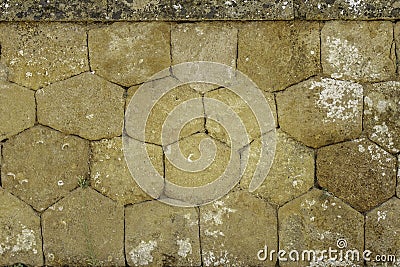 Warm toned closed up of historic honey combed shaped stone wall in Sicily Italy Stock Photo