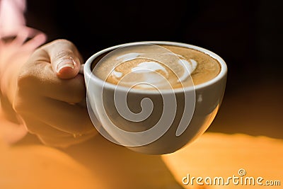 A woman is holding a cup of coffee Stock Photo