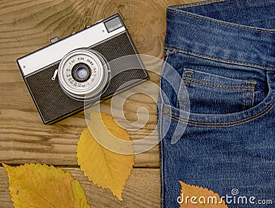 Warm and romantic autumn - jeans, old retro camera, leaves Stock Photo