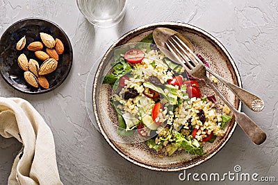 Warm salad with bulgur, vegetables and leaves Stock Photo