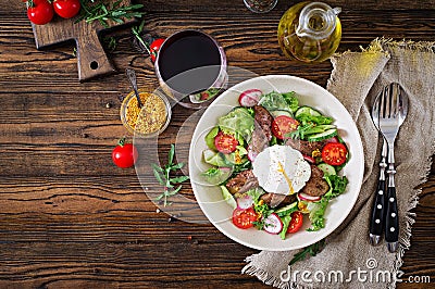 Warm salad from chicken liver, radish, cucumber, tomato and egg poached Stock Photo