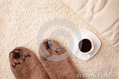 Warm soft blanket, cup of hot espresso coffee, woolen socks. Winter fall autumn cozy still life. Top view point. Copy space. Stock Photo