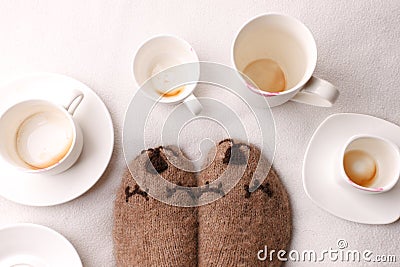 Warm soft blanket, many empty cups of espresso coffee, woolen socks. Winter fall autumn cozy still life. Lazy sleepy weekend Stock Photo