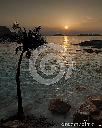 Warm tropical sunrise, sunset with boats waiting for tourists Stock Photo