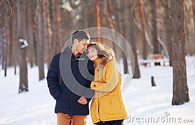 Warm winter portrait of a couple of different race in the forest Stock Photo