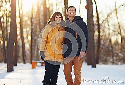Warm winter portrait of a couple of different race in the forest Stock Photo